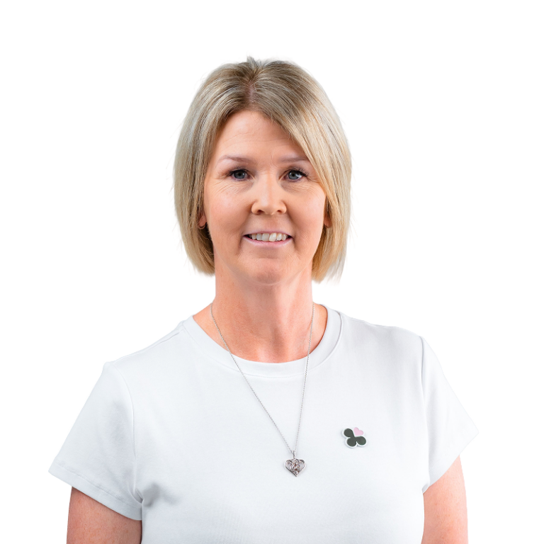 Smiling woman with blonde bob and heart necklace