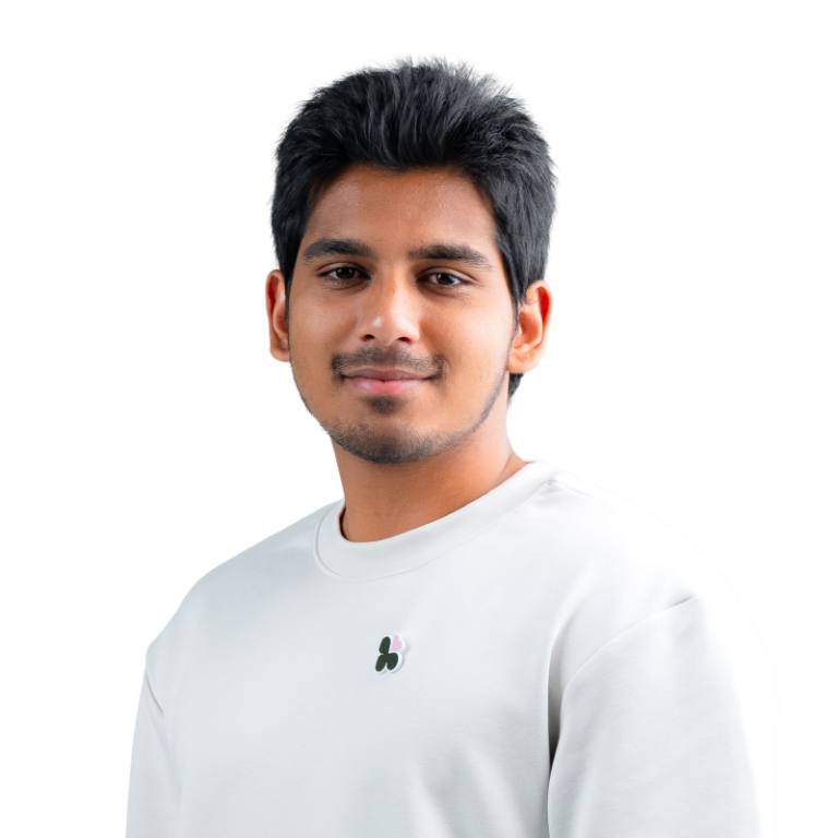 Young man in gray sweatshirt smiling slightly