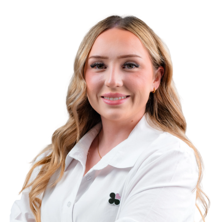 Professional headshot of smiling blonde woman in white blouse